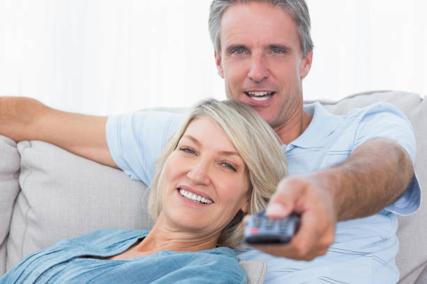 istock Cheerful couple relaxing at home watching tv 847404006