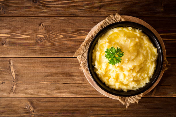 istock Mashed potatoes with butter and fresh parsley in bowl on rustic wooden table 847411334