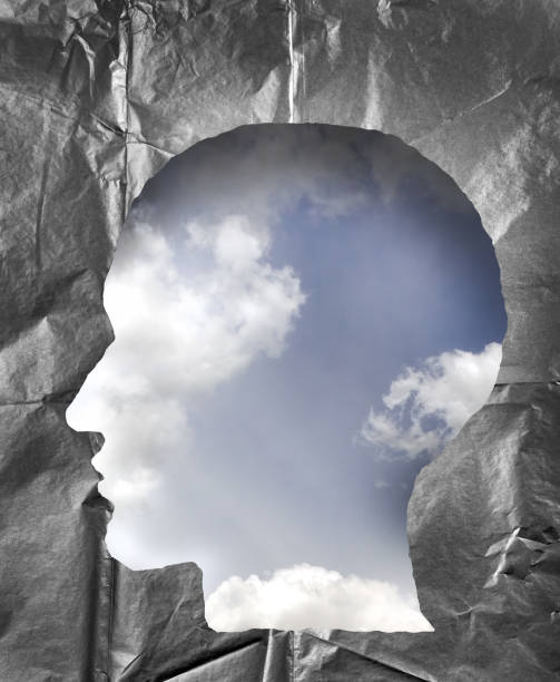 istock Crumpled paper shaped as a human head. Cloudy sky inside the head. Dream, consciousness and imagination concept. 847411364