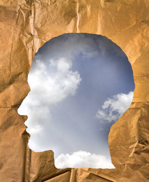 istock Crumpled paper shaped as a human head. Cloudy sky inside the head. Dream and imagination concept. 847411366