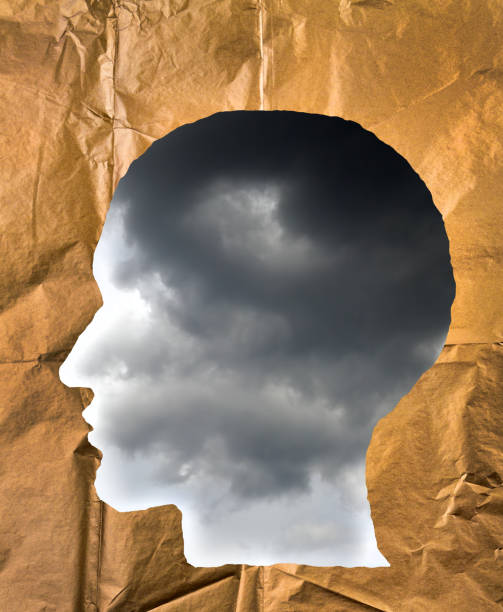 istock Crumpled paper shaped as a human head. Stormy sky inside the head. Negative and imagination concept. 847411404