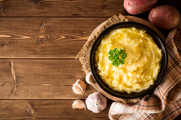 istock Mashed potatoes with butter and fresh parsley in bowl on rustic wooden table 847412224