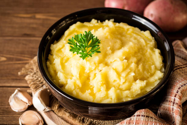 istock Mashed potatoes with butter and fresh parsley in bowl on rustic wooden table 847412452
