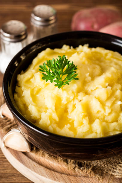istock Mashed potatoes with butter and fresh parsley in bowl on rustic wooden table 847412682