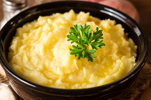 istock Mashed potatoes with butter and fresh parsley in bowl on rustic wooden table 847414772