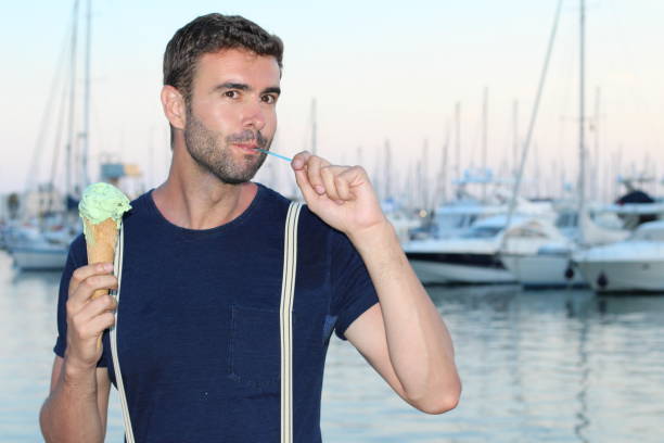 istock Man eating ice cream with a spoon 847418990