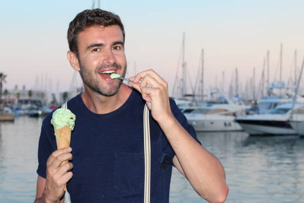 istock Man eating an icecream with a spoon 847419020