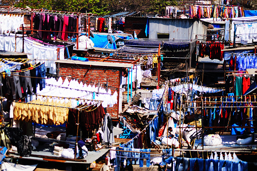 Dhobi ghat - open air laundromat in Mumbai, India. Colorful India. Traditional work for Indian people. Locally known as Dhobis, work in the open to wash the clothes from Mumbai's hotels and hospitals.