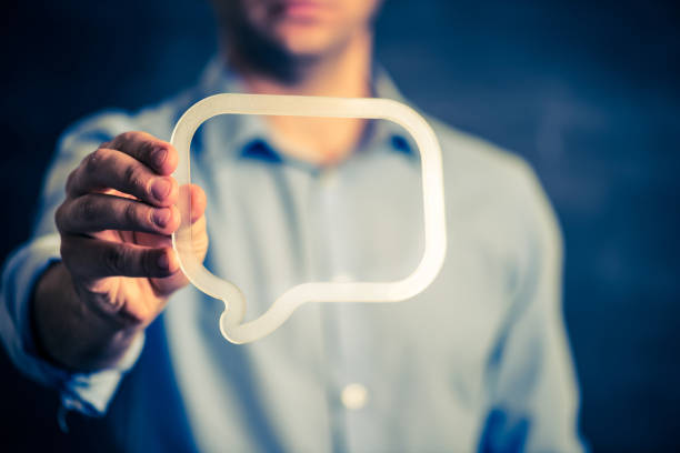 Businessman holding a transparent speech bubble