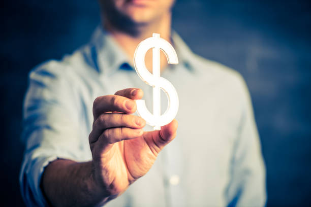 istock Businessman holding a dollar symbol 847419700