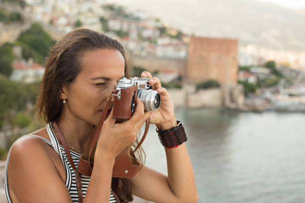 istock Traveller woman photographing using vintage camera 847422986