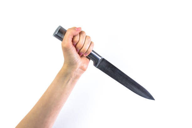 Woman hold kitchen knife in hand isolated on white background. Close up