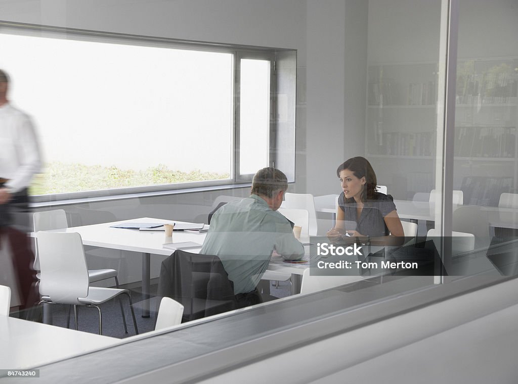 Co-workers talking in conference room  20-24 Years Stock Photo