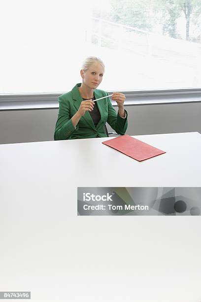 Businesswoman Sitting At Conference Table Stock Photo - Download Image Now - Conference Table, Copy Space, 25-29 Years