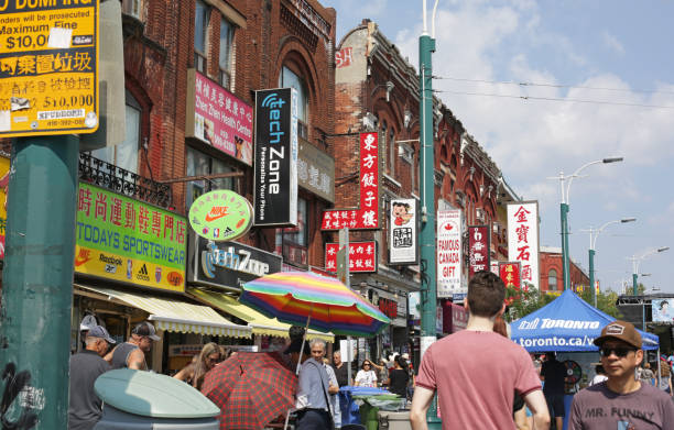 Toronto, Canada - August 20, 2017: Shopping in Toronto's Chinatown, Spadina Avenue in summer. Colorful signs in the multi-cultural downtown Kensington neighbourhood.