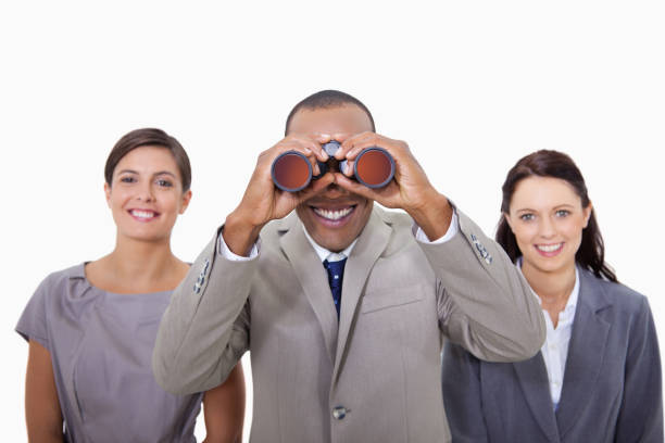 istock Businessman with colleagues looking through binoculars 847445086