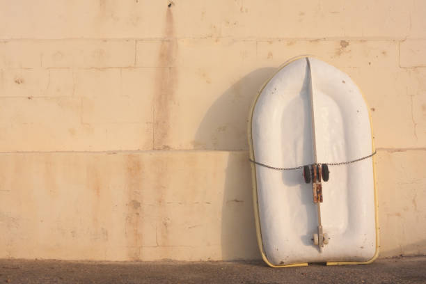 istock small dingy leaning against a wall in sunshine 847452436