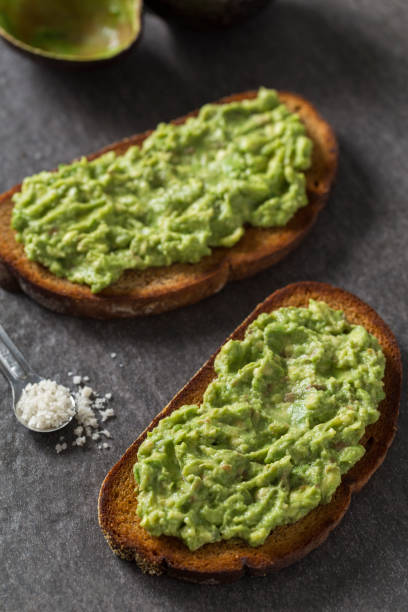 Avocado Toast A healthy breakfast of avocado toast. toasted bread stock pictures, royalty-free photos & images