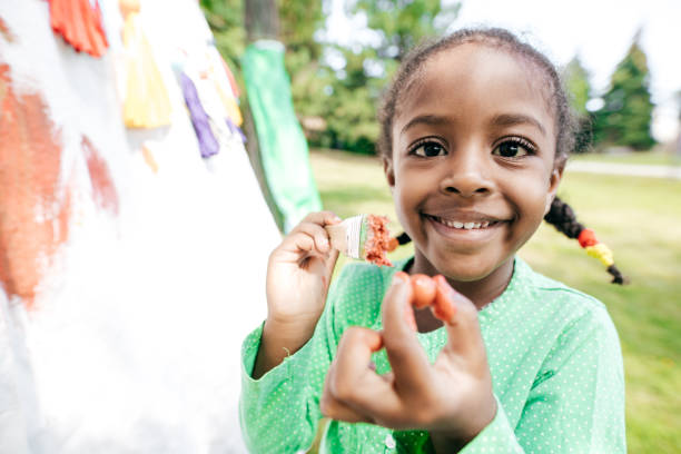 istock Smiling girl with a paintbrush 847459160