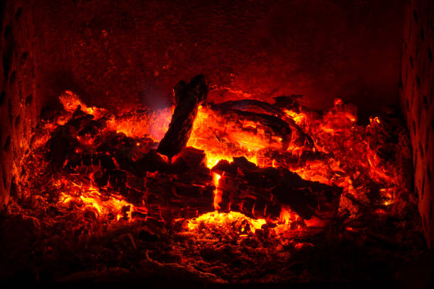istock Embers with burned logs and ashes in a fireplace with warm atmosphere 847466878