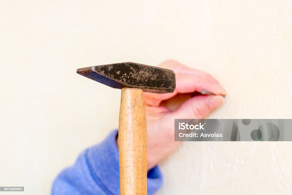 Hammer A Nail Into A Wall As A Close Up Stock Photo - Download Image Now -  Adult, Business Finance and Industry, Carpenter - iStock