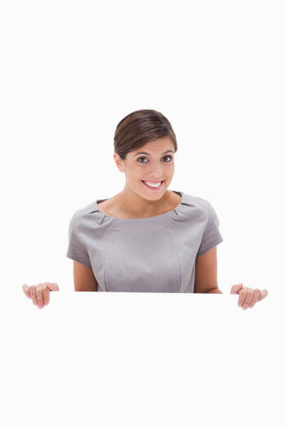 istock Smiling woman looking over blank wall 847472710