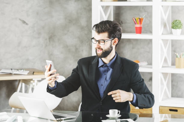 istock Smiling businessman with smartphone 847472968