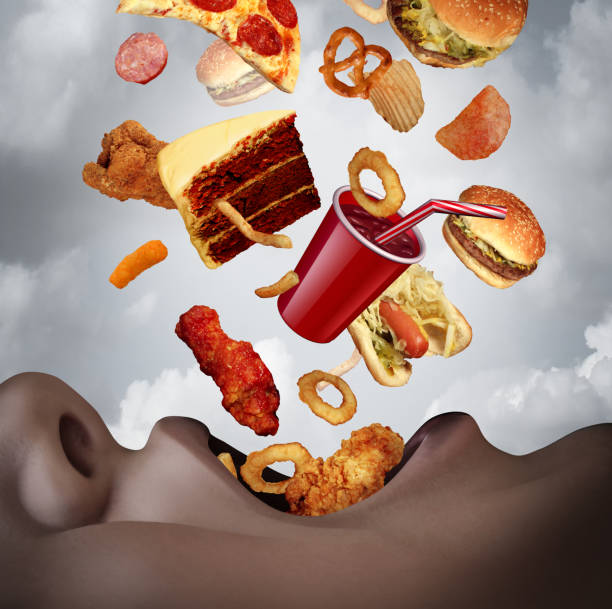 Eating An Unhealthy Diet Eating an unhealthy diet as a human mouth binging on high calorie food as a hamburger pizza and cake falling into open hungry lips with 3D illustration elements. Ready To Eat stock pictures, royalty-free photos & images