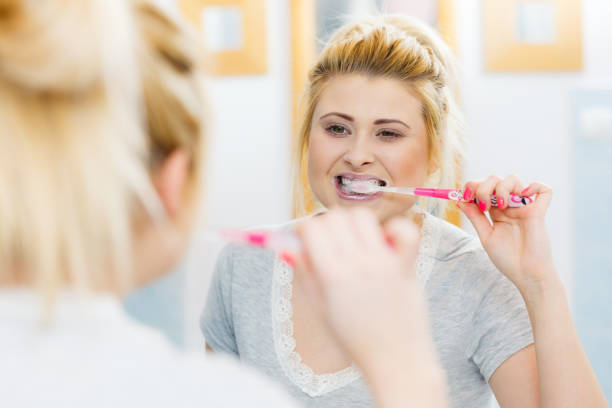 istock Woman brushing cleaning teeth in bathroom 847473144