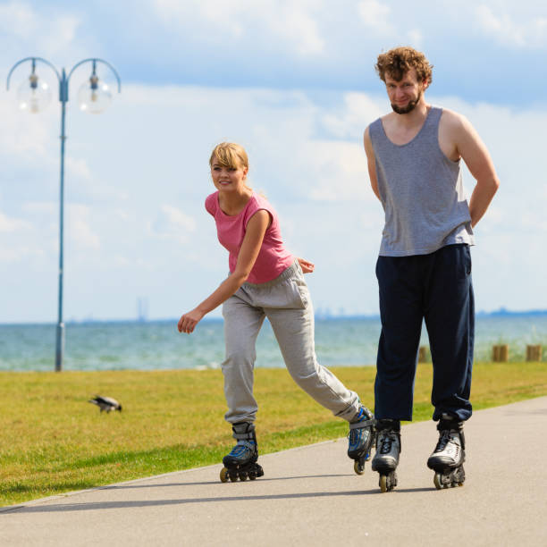 istock Youngsters together skating in seafront park. 847473618