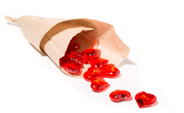 istock Red glass hearts are poured out from a paper parcel 847481342