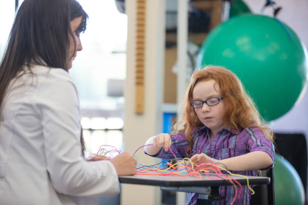 istock Occupational therapist works with young girl 847484284