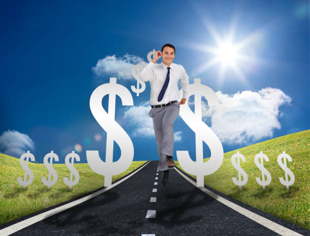istock Businessman running on a road with dollar signs 847484780