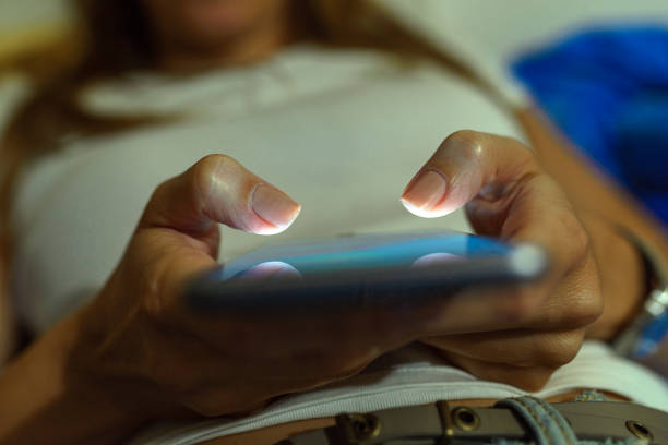 istock Young woman texting on smartphone at home bedroom at night 847488748