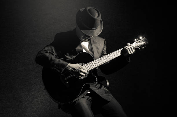 Musician playing the guitar on black background,music concept stock photo