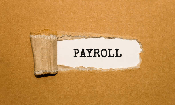 istock The text PAYROLL appearing behind torn brown paper 847506428