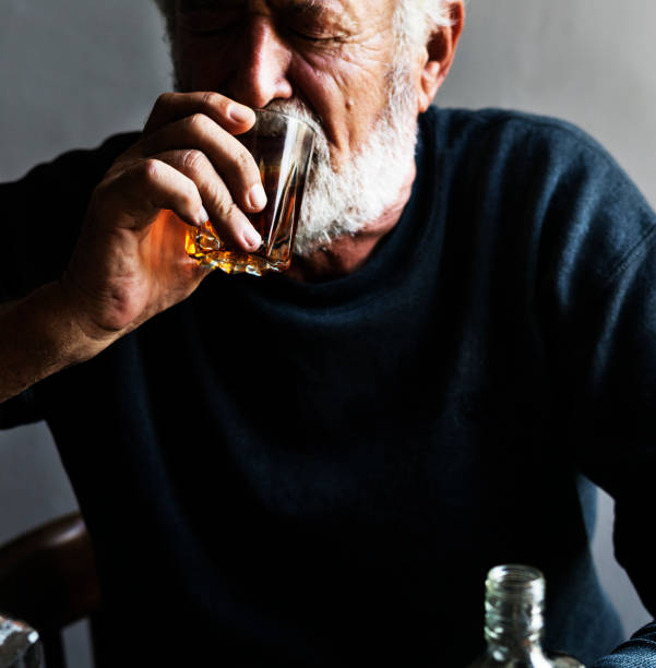 istock Elderly man sitting drinking whiskey alcoholic addiction bad habit 847506580