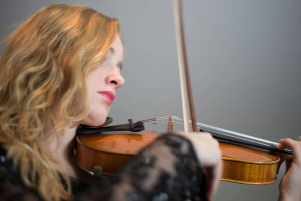 istock Female musician playing violin – Chandelier 847506728