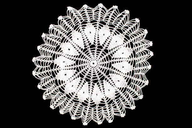 istock White round lace tablecloth isolated on black background 847509712