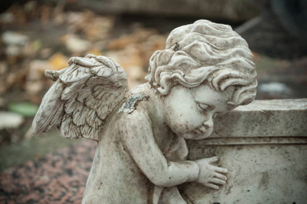 istock stoned angel statue in cemetery 847513546