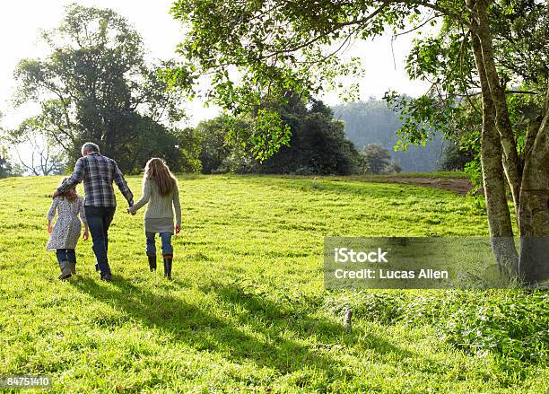 Family Walking Up A Grassy Hill Together Stock Photo - Download Image Now - Family, Rural Scene, Australia