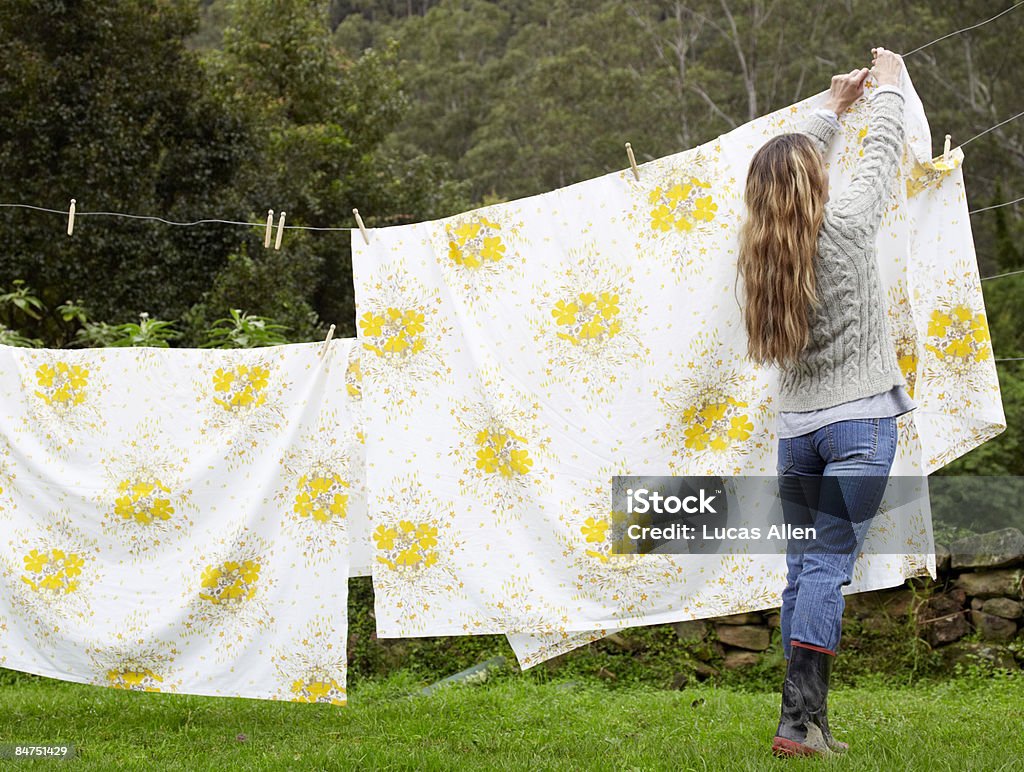 Woman hanging washing on the line  Clothesline Stock Photo