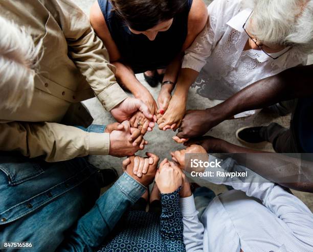 Group Of Diverse Hands Holding Each Other Support Together Teamwork Aerial View Stock Photo - Download Image Now