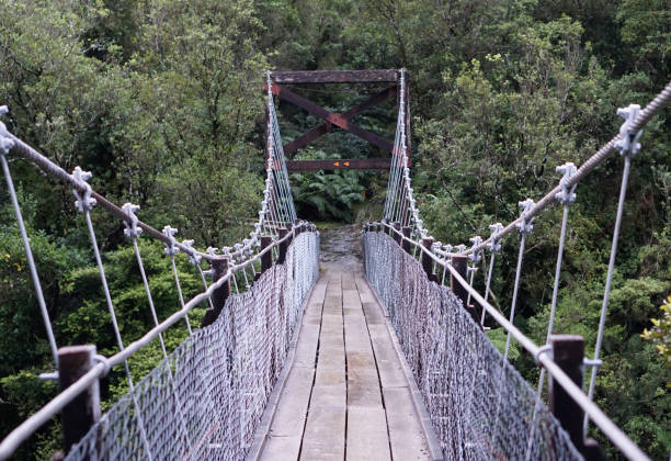 istock Rope bridge at Hokitika Gorge Walk with river under and forest background 847523576