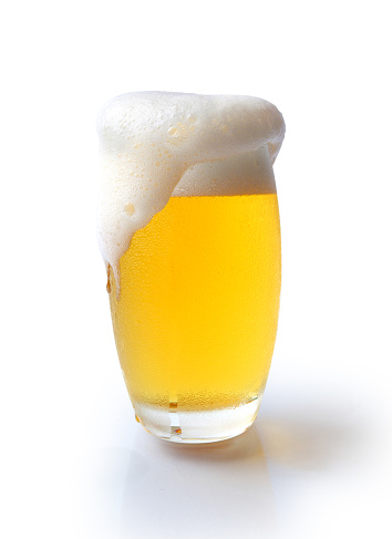 cold glass mug of beer with foam with bratwurst hotdog with sun beams