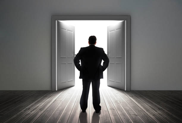istock Businessman looking at door showing bright light 847534692