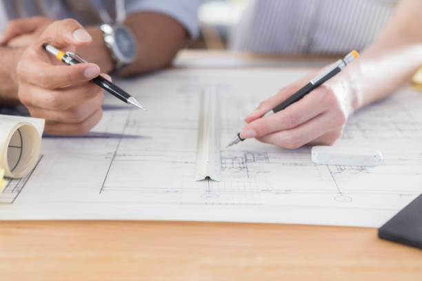 istock Male and female architects work on plans 847535836