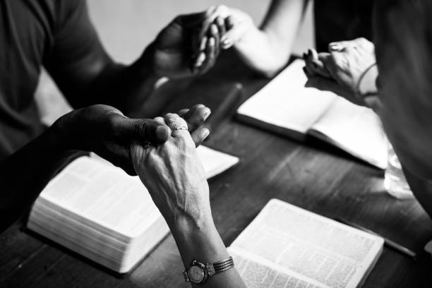 istock Group of people holding hands praying worship believe 847542176