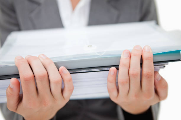 istock Pile of paperwork being held by female hands 847546256