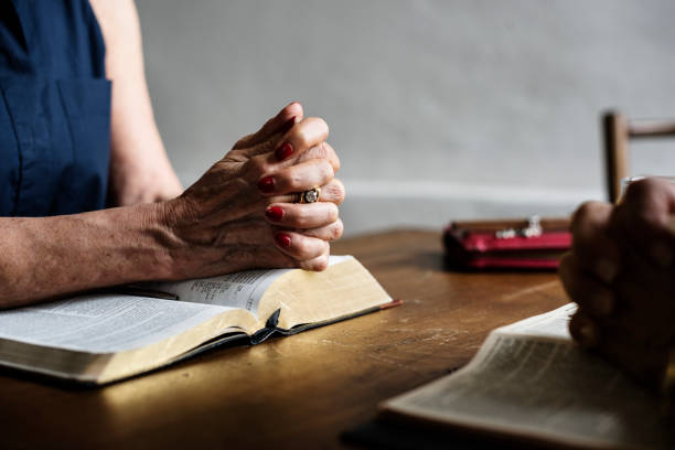 istock Christianity people praying reading bible 847546900